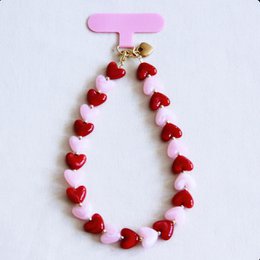 Stainless steel earrings with heart-shaped charms in pink and gold colors.