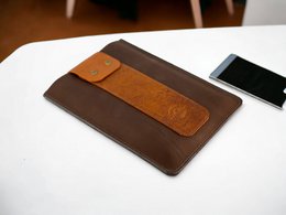  Tablet case made of cowhide leather, available in 8-inch and 10-inch sizes, with a brown and orange color scheme.
