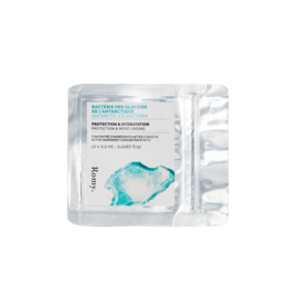 Turquoise-colored capsule containing Antarctic glacier bacteria for use as a cream or skincare product.