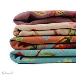 Ecru hammam towels with colorful floral patterns, striped designs, lightweight cotton material, perfect for spa and beach use.