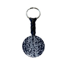  Circular black and white keychain with a metal ring for attaching to keys. Textured surface with a speckled pattern.