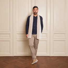  Beige scarf with intricate pattern, made of soft, high-quality material.