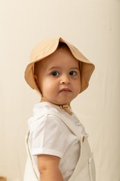Soft, cozy cappuccino-colored bonnet for babies 0-12 months. Made of high-quality, breathable materials to keep your little one comfortable and stylish.