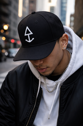 Black baseball cap with white logo, adjustable strap for comfortable fit.