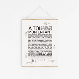 A poster featuring the text "A toi mon enfant" in a vintage-inspired style. The poster has a minimalist, black and white design with a simple frame. This wall art piece would be suitable for a nursery or child's room.