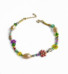 Colorful floral bracelet with pink and pearl beads

The bracelet features a delicate floral design with pink and pearl beads, creating a feminine and elegant accessory. The mix of colors and materials adds visual interest and texture to the piece.