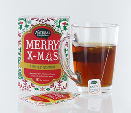 A festive, limited edition tea with a red and green holiday-themed label featuring the text "Merry X-Mas" and decorative elements like holly and berries.