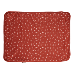 Rectangular changing mat with a savanna-inspired pattern in shades of red.