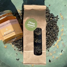 China Jasmin tea, a fragrant and delicate green tea with a smooth, sweet flavor. Packaged in a simple, natural-looking box.