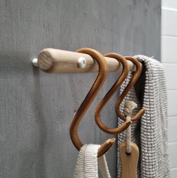 Natural leather S-hooks for clothing racks, with a simple, curved design.