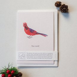 A vibrant red cardinal bird with the text "You rock!" on a greeting card. The card features a beautiful illustration of the northern cardinal, a popular songbird known for its bright red plumage.
