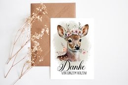 Thanksgiving postcard with a deer illustration and the text "Danke" (German for "Thank you"). The postcard has a kraft paper background with floral accents.