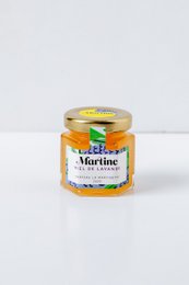 Lavender-infused honey in a glass jar. The honey has a light purple color and a floral aroma, indicating the presence of lavender. The jar label prominently displays the "Martine" brand name.
