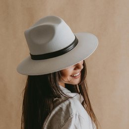 White panama style hat with a black band.