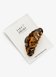 Tortoiseshell-patterned hair clip with a sleek, modern design. Made of durable plastic material. Suitable for casual or formal hairstyles.