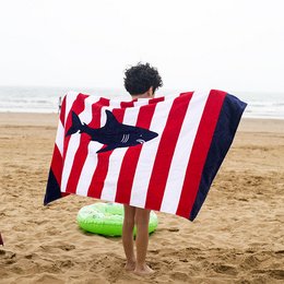 Striped beach towel with colorful floral design, suitable for children's use during summer activities on the beach.