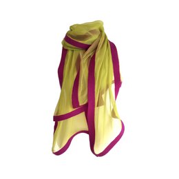Vibrant scarf in shades of yellow, green, and purple. Soft, lightweight material with a stylish color-blocked design. Versatile accessory that can be worn in multiple ways.