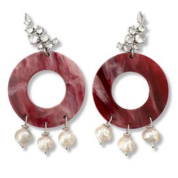  Elegant pearl and crystal earrings with a bold, red circular design. The earrings feature a mix of materials, including pearls and crystals, creating a stylish and sophisticated look.