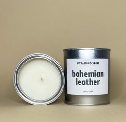 Tall, round scented candle with a bohemian leather fragrance.