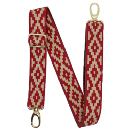 A red and white patterned strap with a gold clasp, attached to a light pink handbag with a red accent.