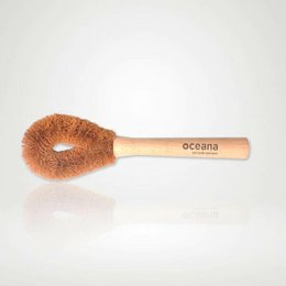Bamboo and coconut fiber dish brush with Oceana branding. The brush has a round, natural bristle head and a wooden handle. The product is designed for eco-friendly, zero-waste cleaning.