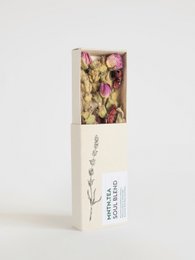 Delicate pink and yellow dried flowers in a minimalist white box, a soothing and natural tea blend.