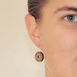 Circular hoop earrings in silver or gold-plated silver with a textured, dotted pattern.