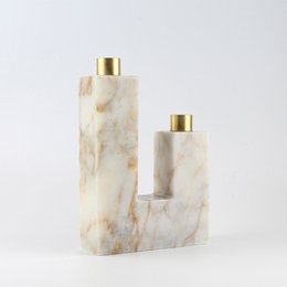 Elegant marble candle holder with gold accents. Features a rectangular shape and a smooth, natural stone texture.