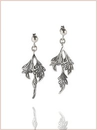  Elegant drop earrings featuring a delicate leaf design in gold and burnished finishes. The earrings have a sophisticated and nature-inspired look.