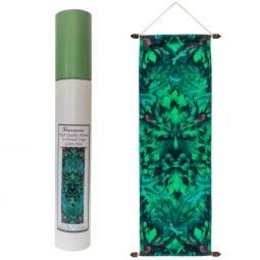 A large, green, cylindrical candle with a textured surface, surrounded by a decorative green and black patterned banner or wall hanging.