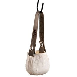 A round, tall, crinkly white candle holder with a brown leather strap for hanging.