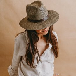 Green panama style hat with a woven texture and leather band.