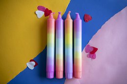  Colorful rainbow-themed dinner candles in a variety of vibrant hues, including pink, orange, yellow, green, blue, and purple. The candles are cylindrical in shape and appear to be made of wax.
