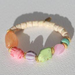 Colorful beaded bracelet with assorted beads and charms, including a heart-shaped charm and text that reads "La vie".