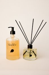  Luxurious reed diffuser set with a floral garden of roses scent. Features a glass bottle with a black reed diffuser.