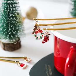  Spoon with Christmas decoration - silver or gold - 6 models. Coffee Spoons with various Christmas-themed decorations including money, crowns, Santa hats, Christmas trees, stockings, deer, and bells in silver or gold colors.