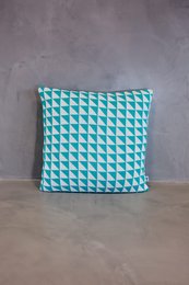 Cushion cover with a geometric pattern in light blue and white. Made of a soft, textured material. Suitable for use as a decorative accent piece in a living room or bedroom.