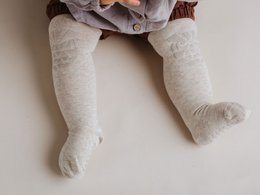 Soft, cozy baby crawling tights featuring a whimsical owl print design. Made from comfortable, breathable material for easy movement. Available in sizes 6-12 months and 12-18 months.