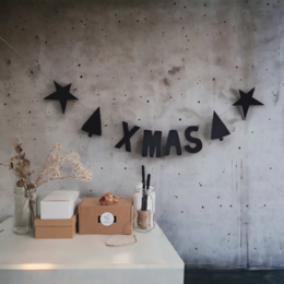 DIY Christmas garland with black, white, and black/white mix color variants. Features a decorative banner with "XMAS" text and star shapes.