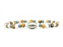 A bracelet made of natural stones in various colors, including green, gray, and brown. The bracelet has a mix of different shaped beads and a central oval-shaped bead.