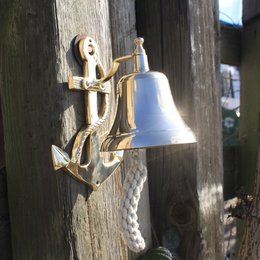 Anchor-shaped bell with a golden anchor and rope detail, suitable for use in a garden or outdoor setting.
