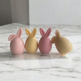 Colorful Easter bunny-shaped candles in various pastel shades, including pink, yellow, blue, green, lavender, and teal. The candles feature either bended or straight ears, creating a whimsical and decorative design perfect for Easter celebrations.