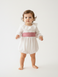 White baby dress with lace collar and pink sash. Suitable for formal occasions.