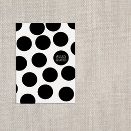 A black and white polka dot postcard with the text "All the best" printed on it.
