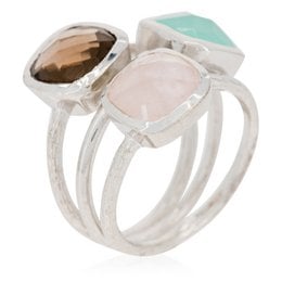 Silver ring with cushion-cut stones in shades of pink, green, and brown. Elegant and stackable design.