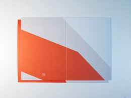 A minimalist greeting card with a bold orange and white geometric design.