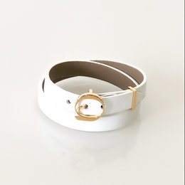  Beige and white leather cuff bracelet with a gold-tone oval buckle closure. Available in sizes XS, S, M, and L.
