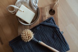 Soft, absorbent muslin tea towels in a variety of neutral colors including white, gray, beige, sage, and blush. Ideal for everyday kitchen use.