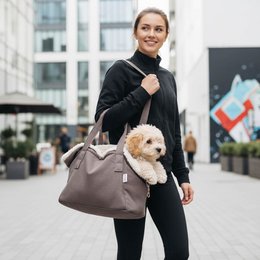  A gray fabric pet bed carrier with a soft, plush interior. The carrier has two handles and appears to be designed for transporting small pets.