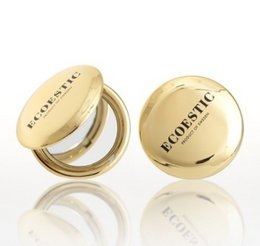 Circular gold-colored makeup mirror with the text "ECOESTIC" printed on the surface.